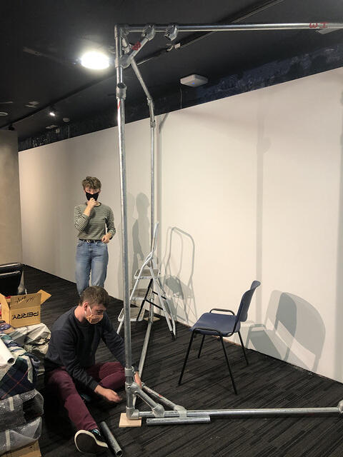 Students assembling a rigging structure in the studio